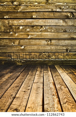 Empty old spacious room with wooden grungy wall and weathered dirty floor, vintage background texture