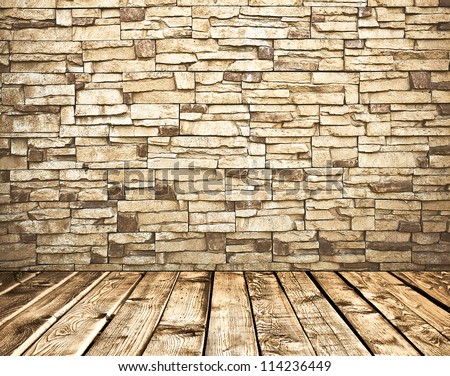 Old stone brick wall and tiled wooden floor inside grungy rural interior