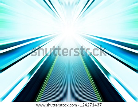 Perspective wide angle view of modern light blue illuminated and spacious high-speed moving commercial escalator with fast blurred trail of handrail in vanishing traffic motion in airport corridor