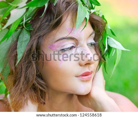 closeup portrait of pretty tender beautiful young female face with clear skin and delicate complexion in the summer evening sunshine in nature
