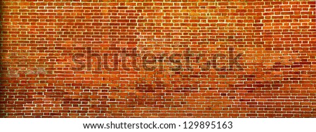 Grungy textured red stone wall inside old neglected and deserted interior, masonry and carpentry brickwork concept