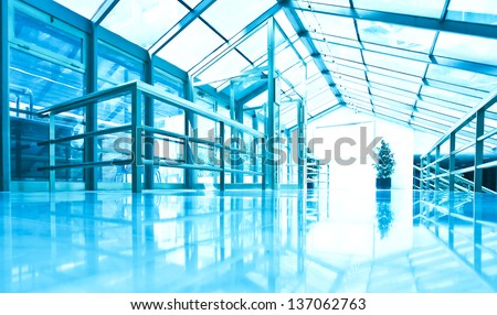 perspective view to steel blue glass airport ceiling through high rise building skyscrapers, business concept of successful industrial architecture
