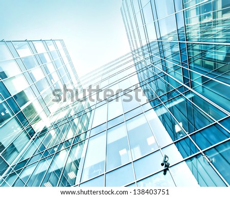 Panoramic and perspective wide angle view to steel blue background of glass high rise building skyscrapers in modern futuristic downtown at night Business concept of successful industrial architecture Panoramic and perspective wide angle view to steel blue background of glass high rise building skyscrapers in modern futuristic downtown at night Business concept of successful industrial architecture