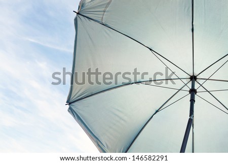 background of white umbrella texture over bright blue sky in sunny hot day