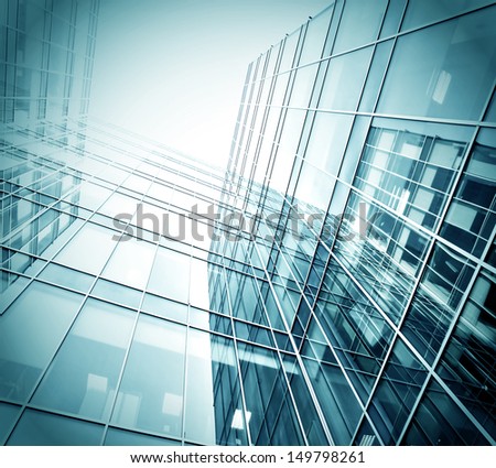 Panoramic And Perspective Wide Angle View To Steel Blue Background Of Glass High Rise Building Skyscrapers In Modern Futuristic Downtown Over Sky Business Concept Of Successful Industrial Architecture