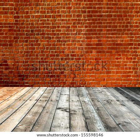 Background of aged grungy textured red brick and stone wall with light wooden floor with whiteboard inside old neglected and deserted empty interior, blank horizontal space of clean studio room