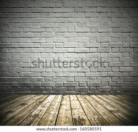 Grungy textured darken white brick room and stone wall with warm brown wooden floor inside old neglected and deserted interior, masonry and carpentry brickwork concept