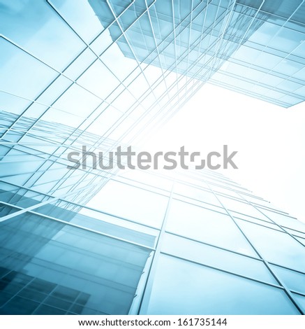 Panoramic and perspective wide angle view to steel blue background of glass high rise building skyscrapers in modern futuristic downtown at night Business concept of successful industrial architecture