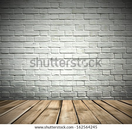 Grungy textured white and gray brick darken room and stone wall with warm brown wooden floor inside old neglected and deserted interior, masonry and carpentry brickwork concept