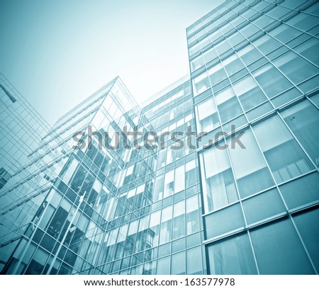 Panoramic And Perspective Wide Angle View To Steel Blue Background Of Glass High Rise Building Skyscrapers In Modern Futuristic Downtown At Night Business Concept Of Successful Industrial Architecture