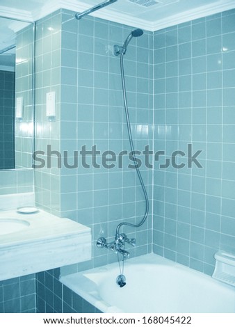 Blue Glossy Ornamental Stone Tiled Wall And Floor In Spacious Bath Room
