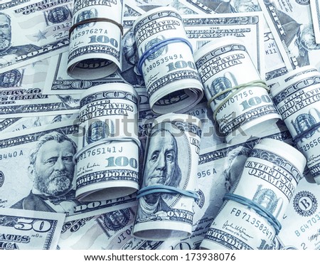 Dollars seamless background. High resolution wallpaper texture of rolled in a tube one hundred and flat fifty banknotes toned in blue