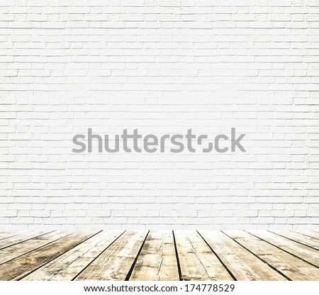 Grungy textured white brick and stone wall with warm brown wooden floor inside old neglected and deserted interior, masonry and carpentry brickwork concept