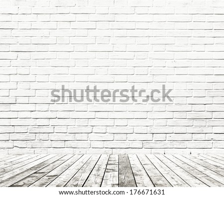Background of aged grungy textured white brick and stone wall with light wooden floor from whiteboard inside old neglected and deserted empty home interior, blank horizontal space of clean studio room