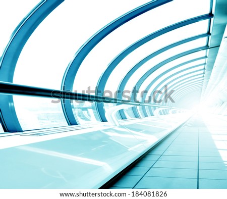Underside wide angled and perspective view to steel blue glass airport ceiling through high rise building skyscrapers, business concept of successful industrial hallway and passageway architecture