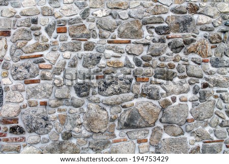 Abstract stonework background texture with old weathered dark stucco black paint stone cement wall in rural room Grungy cold rock surface in hard grime empty place with red specks granite light floor