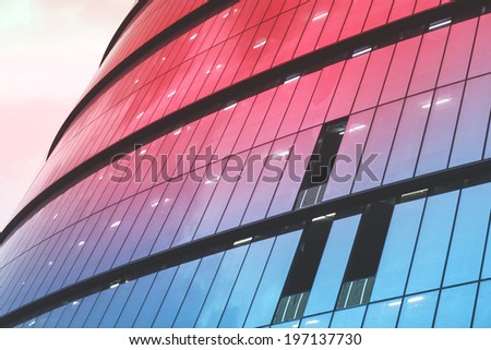 Panoramic and perspective wide angle view to steel light red background of glass high rise building skyscraper commercial modern city of future. Business concept of successful industrial architecture.