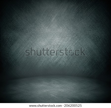 Abstract stonework background texture with old weathered dark stucco black paint stone cement wall in rural room. Grungy cold rock surface in hard grime empty place with gray granite dull light floor.