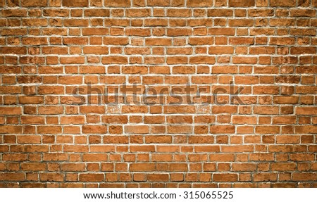 Abstract weathered texture of stained old dark stucco brown and painted red, yellow brick wall background in rural room. Grungy rusty square blocks of darken stonework retro color architect wallpaper.