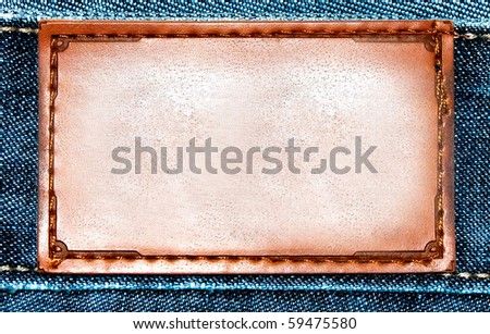 Brown leather label over blue jeans