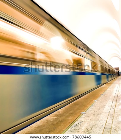 underground platform with moving train