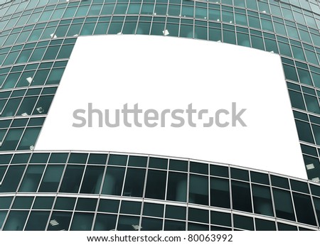 blue glass wall with blank placard of skyscraper