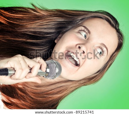 beautiful singer woman with microphone in hand