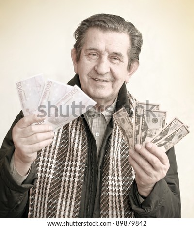 elderly happy man with pack of money