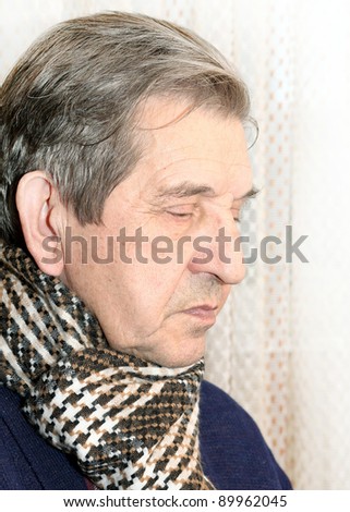 Profile of elderly man with scarf dreaming