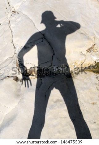 The shadow of the photographer on the coastal cliff
