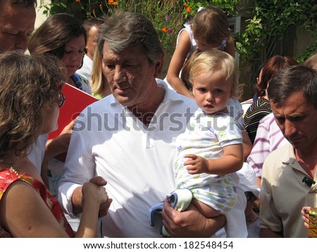 Crimea, Sevastopol-circa August 2005: Former Ukrainian President Viktor Yushchenko meets with people. On his hands - youngest son Taras.