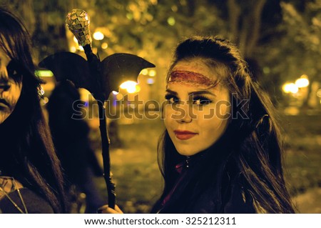 Odessa, Ukraine - OCTOBER 31, 2014: People in costumes pose for fashion masquerade party during the Halloween event in the City Garden October 31, 2014 in Odessa.