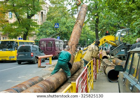 ODESSA, UKRAINE - 09 October 2015: Repair and replacement of outdated pipes in the city center. Welding pipeline segments.
