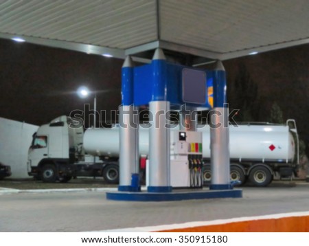 Abstract blurred fuel truck in gas station. Night Scene. Great background