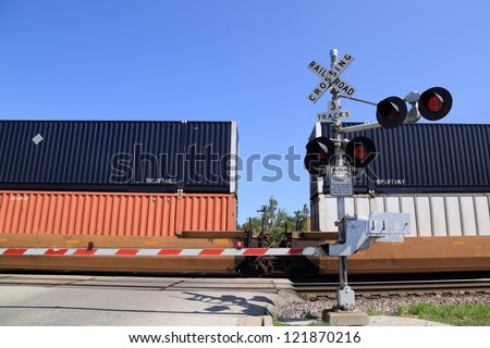 Freight train at railroad crossing gate