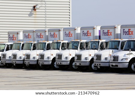 Chicago, Illinois, USA - April 6, 2014: A fleet of large FedEx delivery truck parked at a Federal Express facility at the O\'Hare Airport in Chicago.