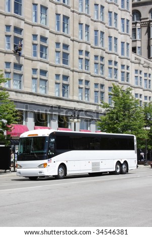 White tour bus in a downtown city area