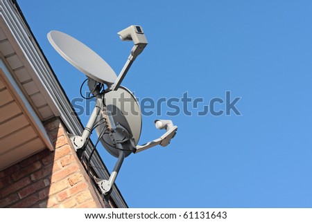Residential satellite dishes pointing to the sky