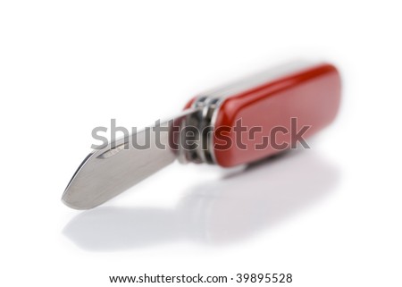 swiss knife with red handle and opened blade captured with short depth of field