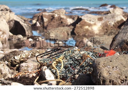 fishing net and gear caught in rocky foreshore, Gisborne, East Coast, New Zealand