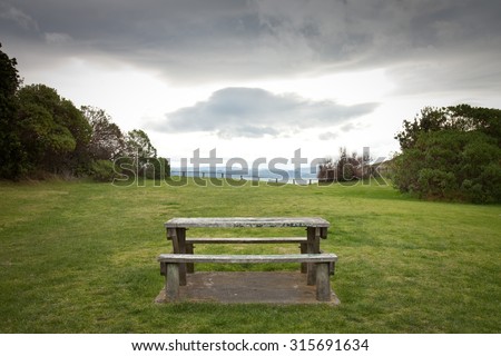 picnic table in a grassy reserve above an ocean beach, sponge Bay, Gisborne, East Coast, North Island, New Zealand