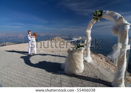 stock photo The newlyweds hugs near the wedding arch and altar against the 