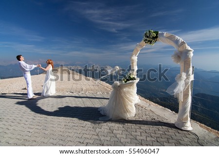 stock photo The newlyweds holding hands near the wedding arch and altar 