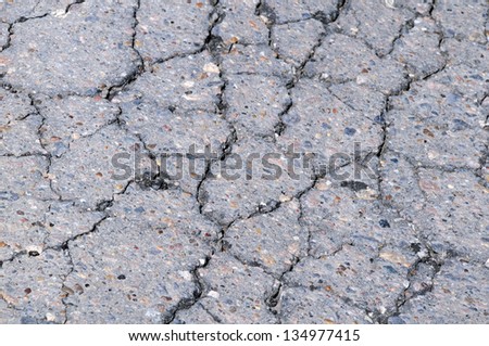 Closeup portion of cracked asphalt road in Kazakhstan