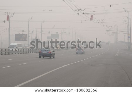 MOSCOW, RUSSIA - AUGUST 7, 2010: Cars run down Krestovsky Bridge in thick smog caused by wildfires