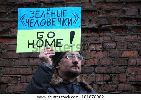 MOSCOW, RUSSIA - MARCH 15, 2014: unidentified man protests holding Go Home sign during Moscow peace rally against Crimean referendum and further occupation of the peninsula