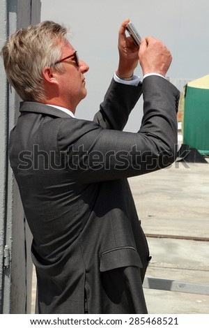 BAIKONUR, KAZAKHSTAN - MAY 27, 2009: Crown prince of Belgium Philippe (now King of the Belgians) takes photos with Sony P&S camera at the cosmodrome before Soyuz spaceship launch