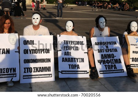 ATHENS, GREECE - MAY 9: People wearing white masks are protesting in the capital of Greece Athens outside the Parliament building against unpopular EU-IMF austerity deal May 9, 2010 in Athens, Greece