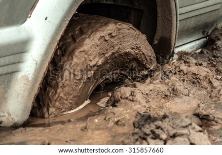 car tire stuck in the mud