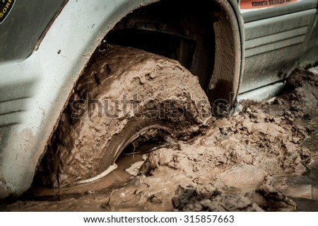 car tire stuck in the mud